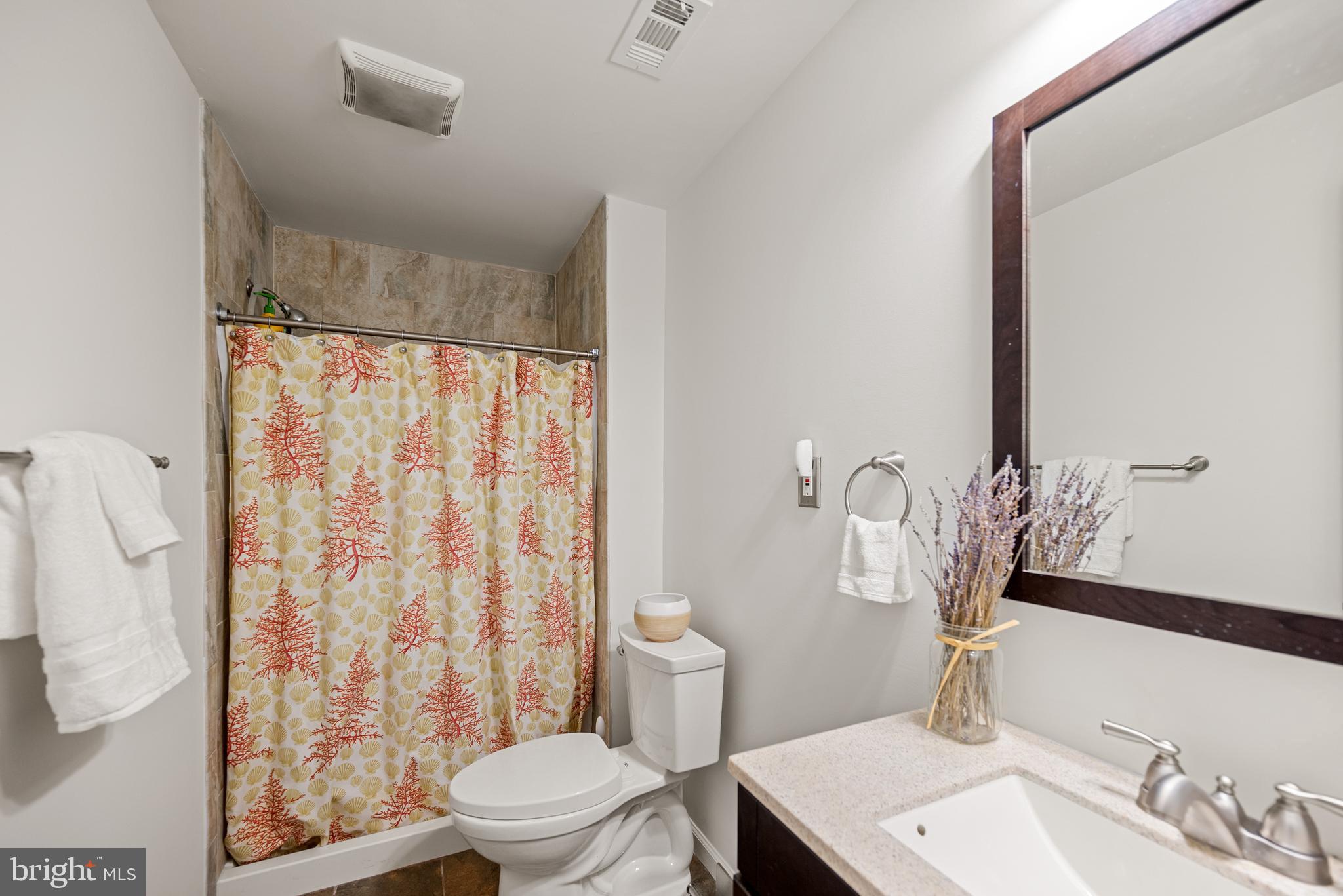 7838 Roundabout Way Springfield, VA 22153 - Photo 39 of 56 a bathroom with a sink a toilet and shower curtain