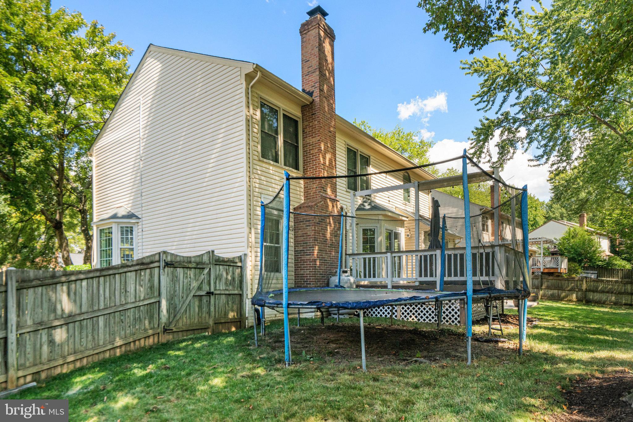 7838 Roundabout Way Springfield, VA 22153 - Photo 46 of 56 a backyard of a house with wooden deck and outdoor seating