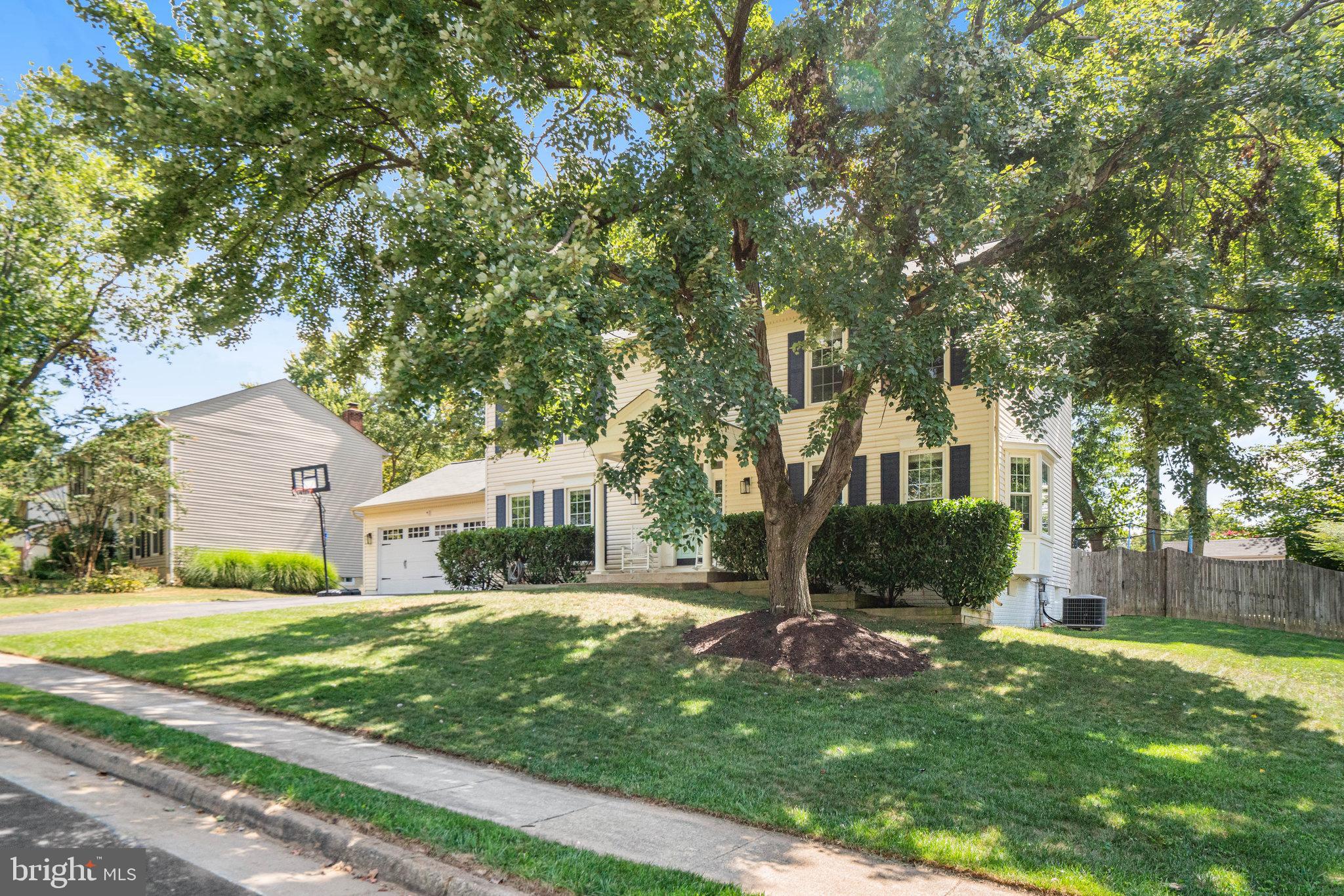 7838 Roundabout Way Springfield, VA 22153 - Photo 51 of 56 a front view of a house with a yard and trees