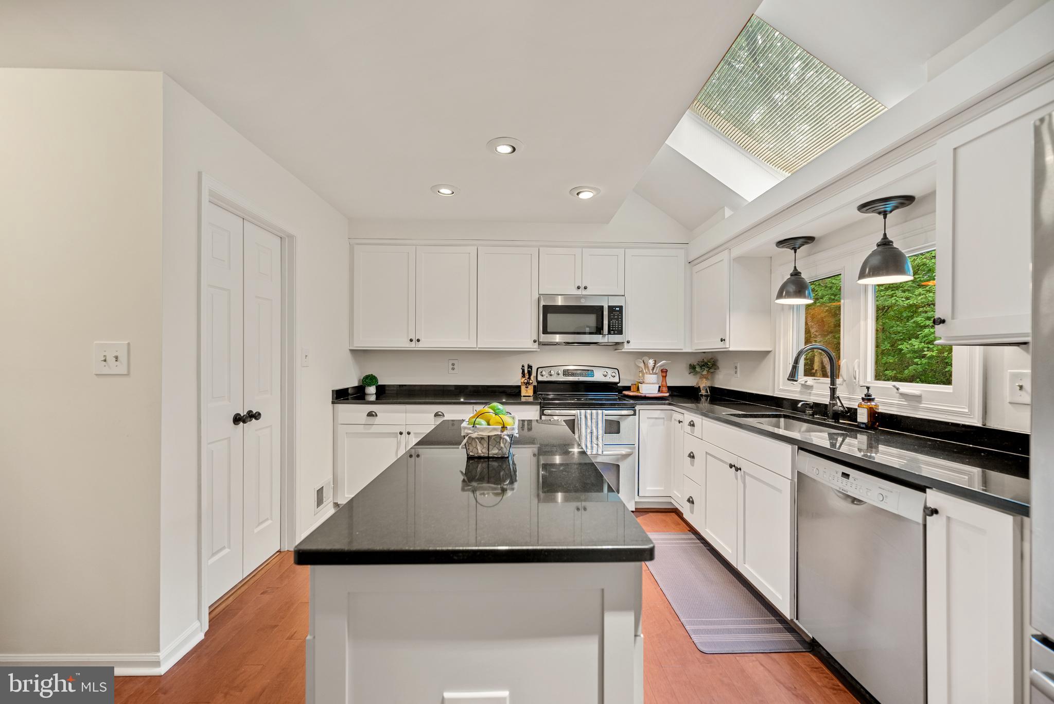 7838 Roundabout Way Springfield, VA 22153 - Photo 8 of 56 a kitchen with appliances a sink and cabinets
