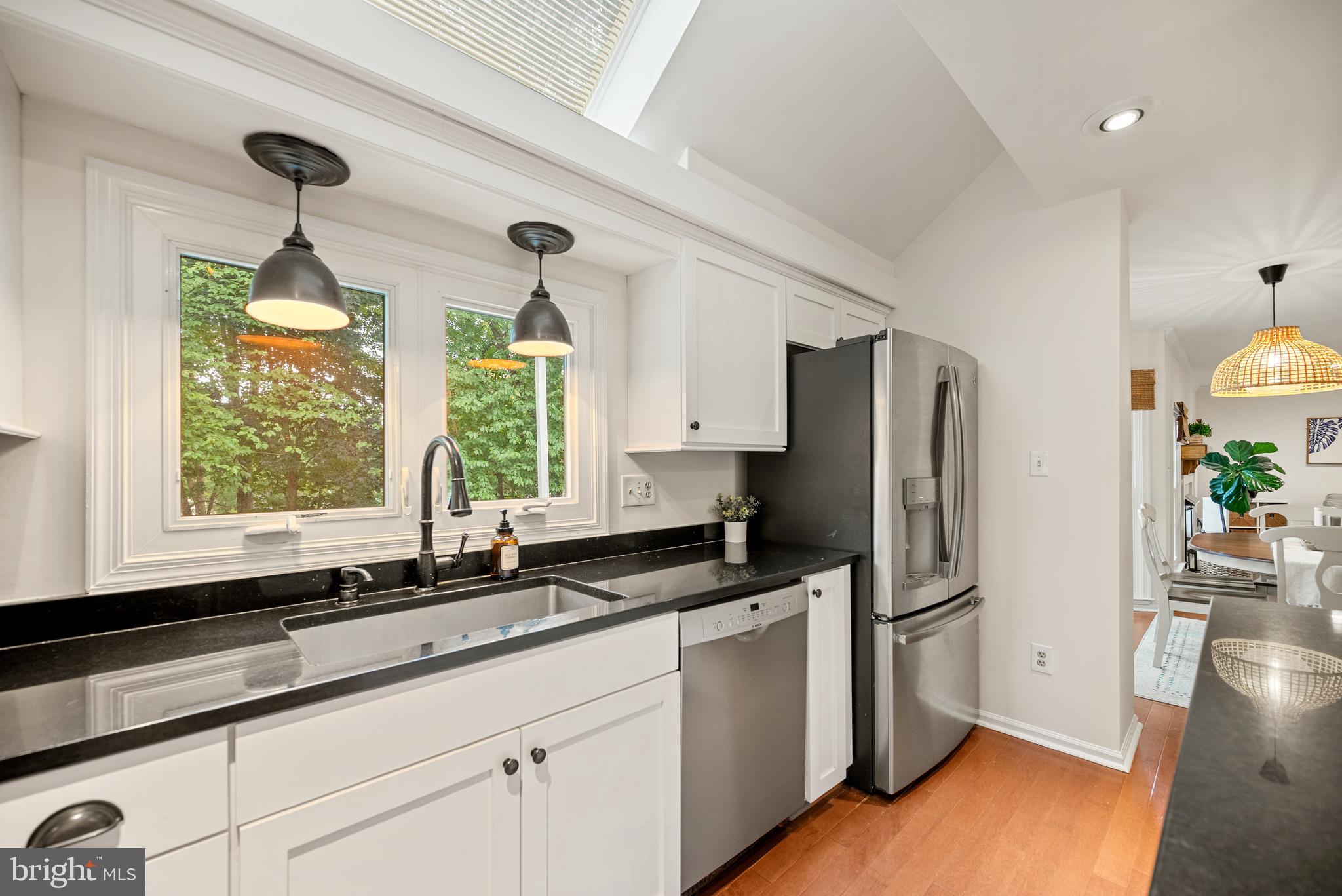 7838 Roundabout Way Springfield, VA 22153 - Photo 9 of 56 a kitchen with stainless steel appliances granite countertop a refrigerator a sink and white cabinets
