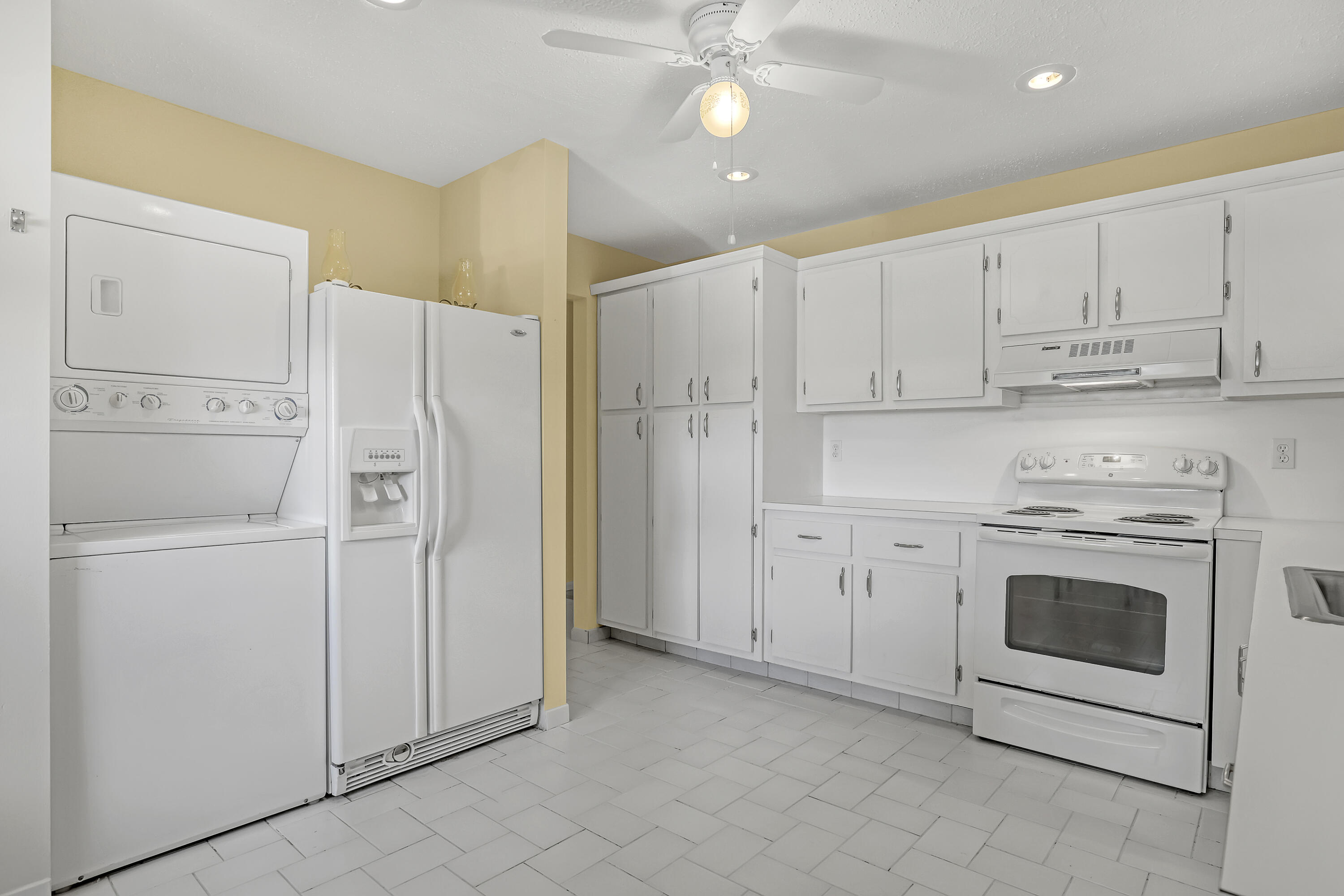 1850 Northwest 18th Street, Unit 103 Delray Beach, FL 33445 - Photo 12 of 28 a kitchen with cabinets and stainless steel appliances