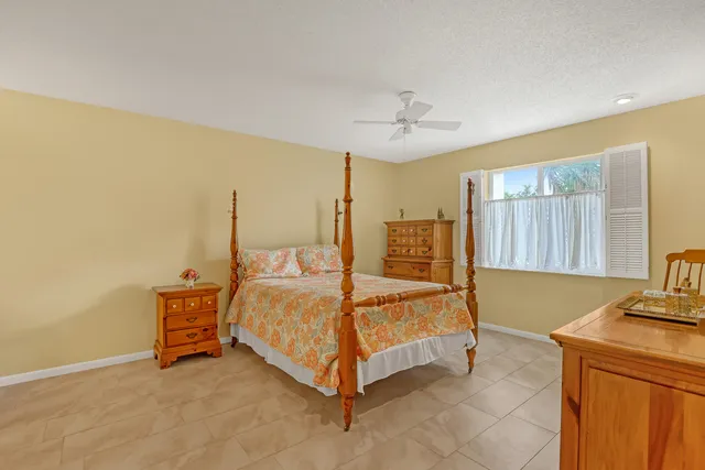 a bedroom with a bed dresser and mirror
