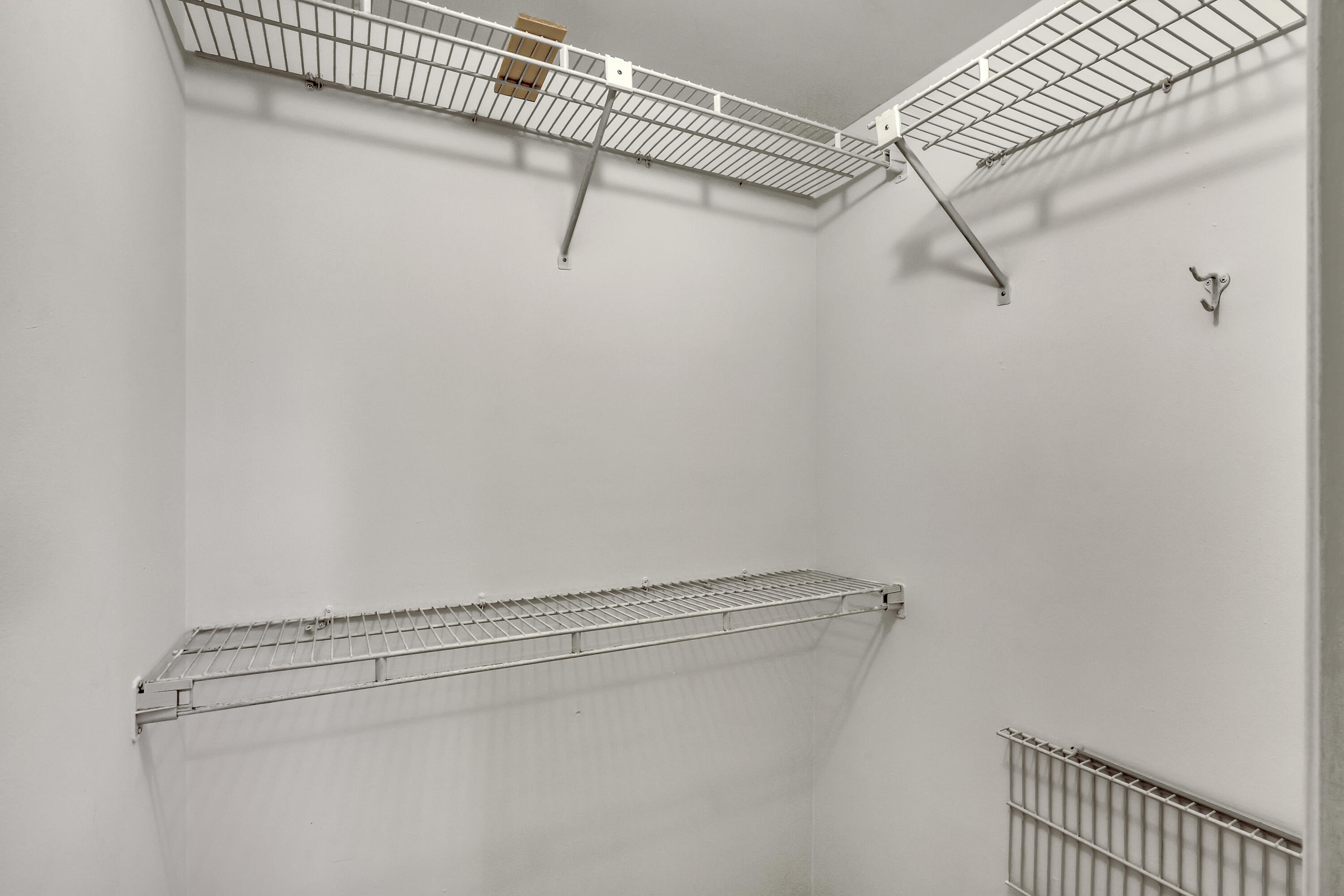 1850 Northwest 18th Street, Unit 103 Delray Beach, FL 33445 - Photo 15 of 28 a view of a room with racks on the wall