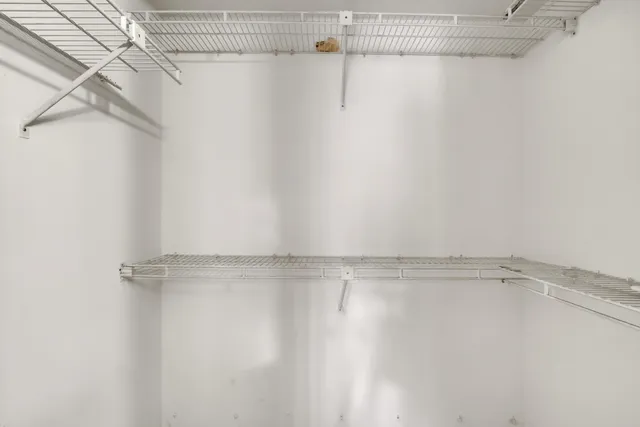 a spacious bathroom with a granite countertop sink and a mirror