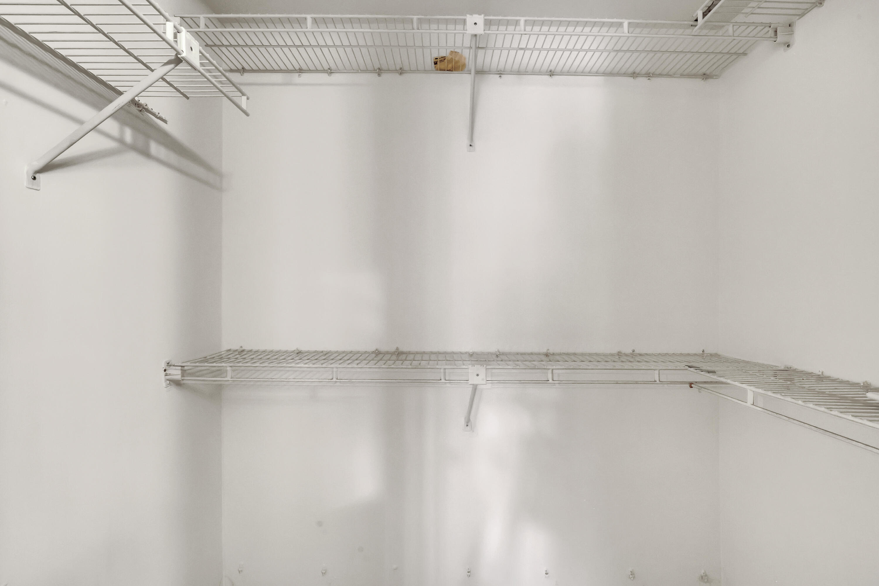 1850 Northwest 18th Street, Unit 103 Delray Beach, FL 33445 - Photo 16 of 28 a view of a room with racks on the wall