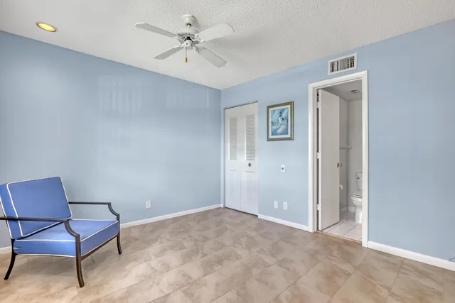 a view of a room with wooden floor and ceiling fan