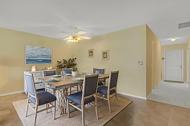 a view of a dining room with furniture and chandelier