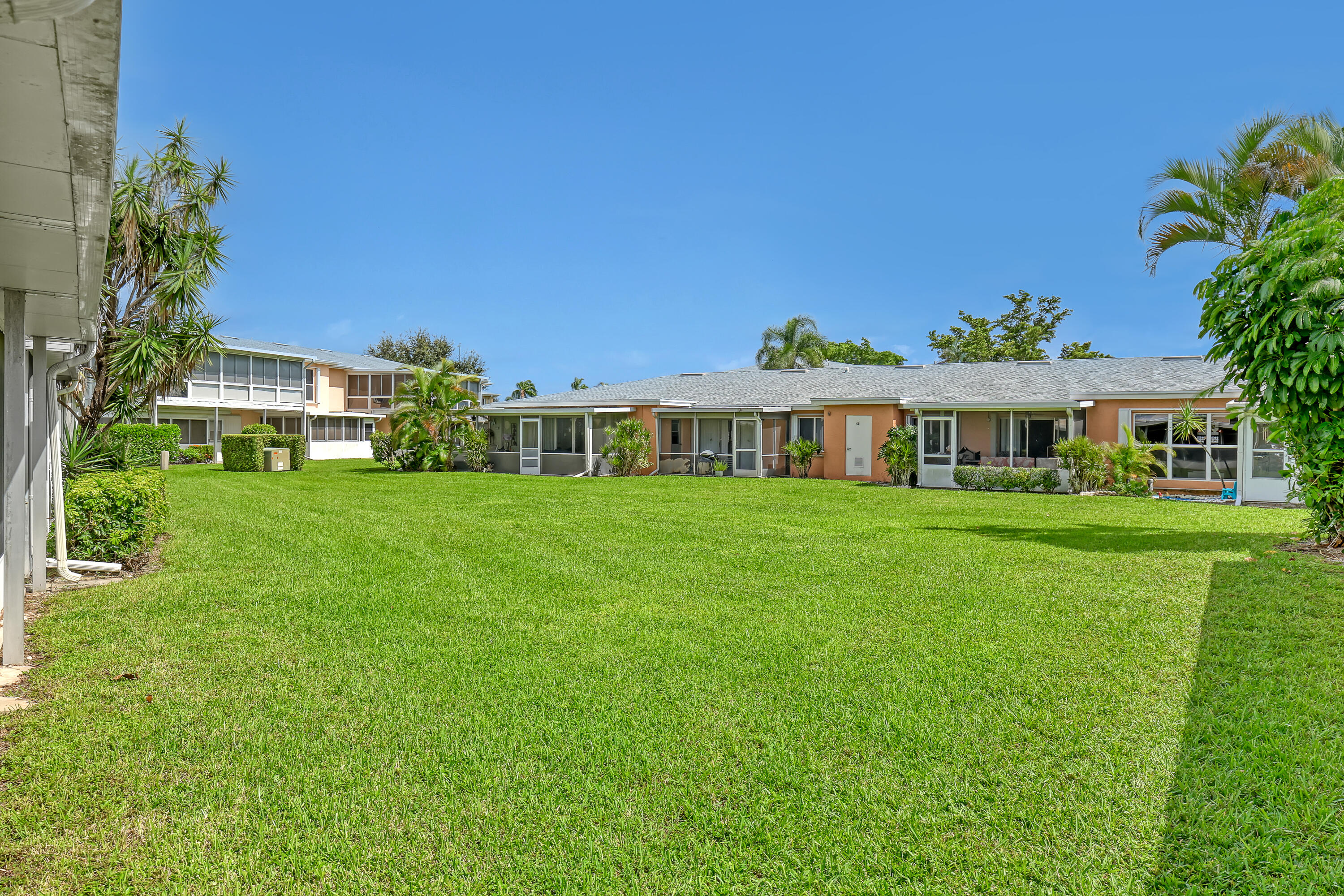 1850 Northwest 18th Street, Unit 103 Delray Beach, FL 33445 - Photo 27 of 28 a front view of a house with a garden