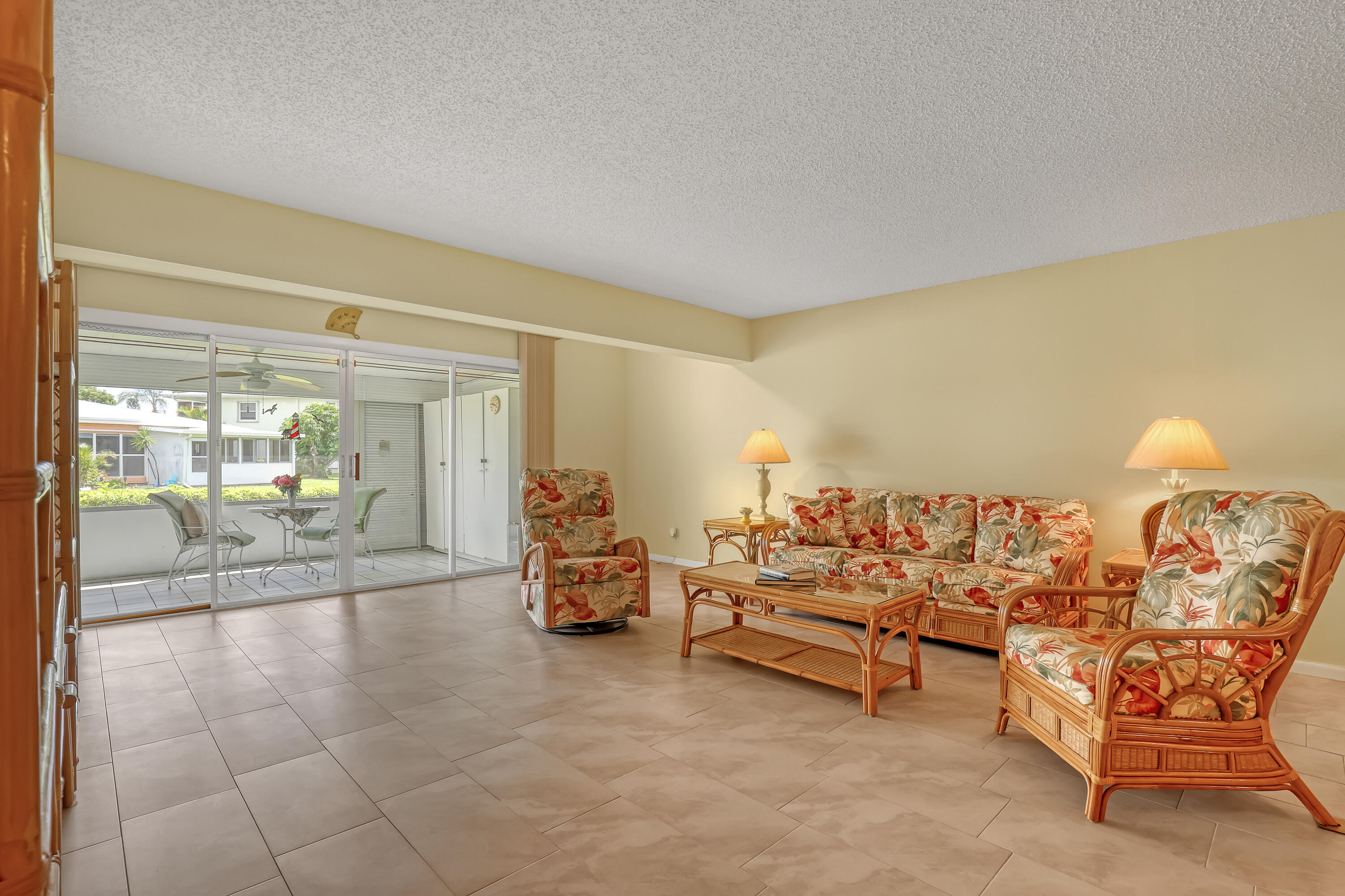 1850 Northwest 18th Street, Unit 103 Delray Beach, FL 33445 - Photo 6 of 28 a living room with furniture and a chandelier