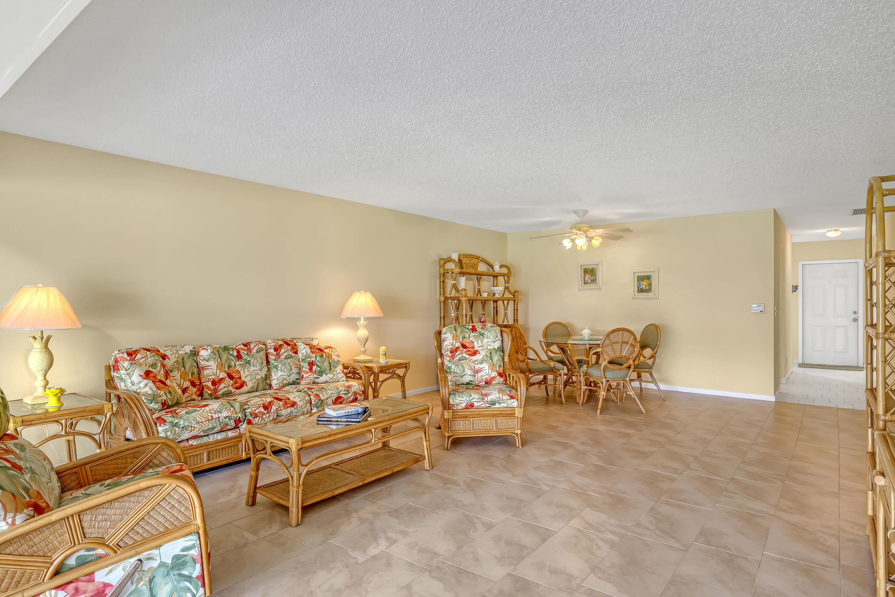 1850 Northwest 18th Street, Unit 103 Delray Beach, FL 33445 - Photo 9 of 28 a living room with furniture and a table