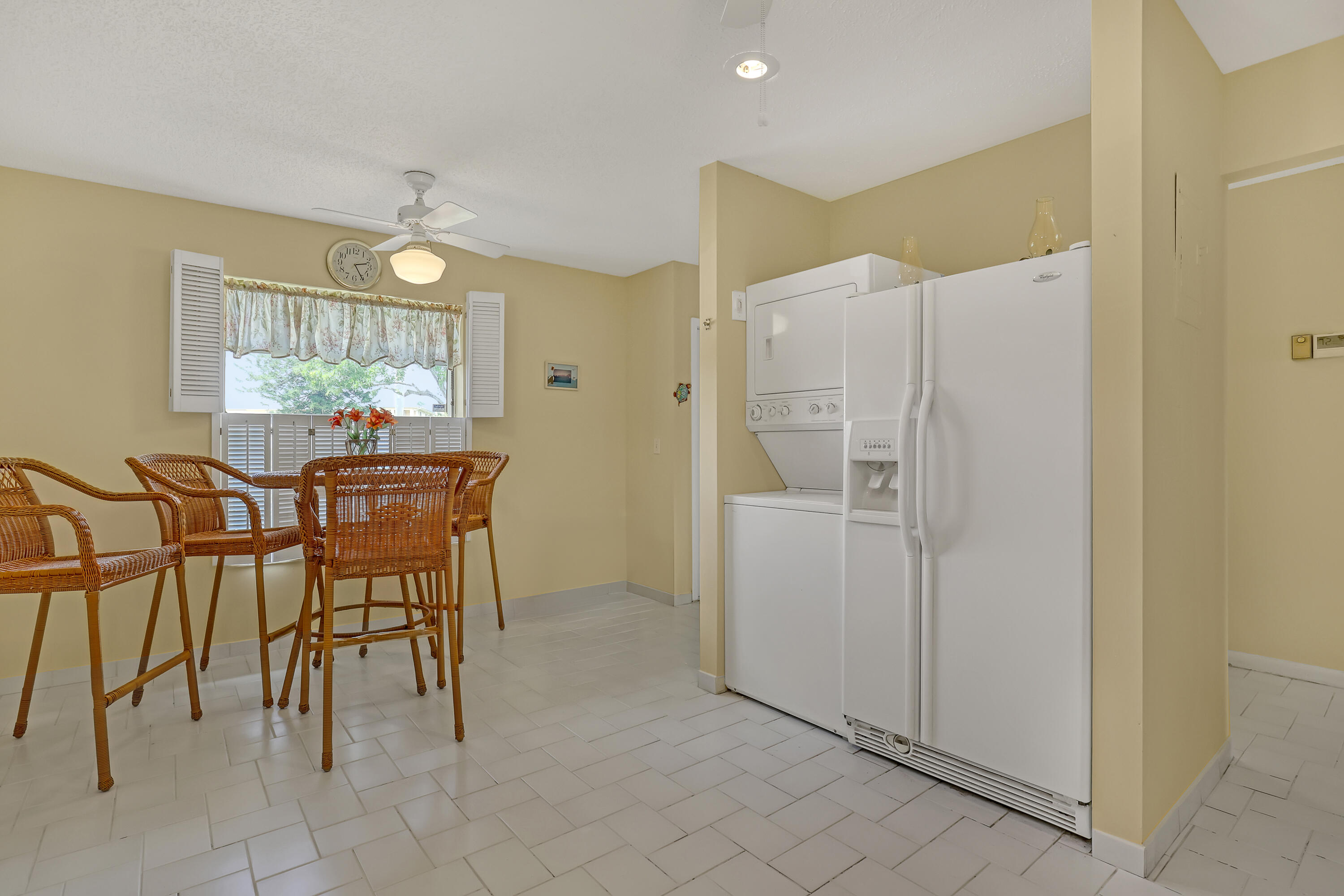 1850 Northwest 18th Street, Unit 103 Delray Beach, FL 33445 - Photo 10 of 28 a dining room with furniture and window