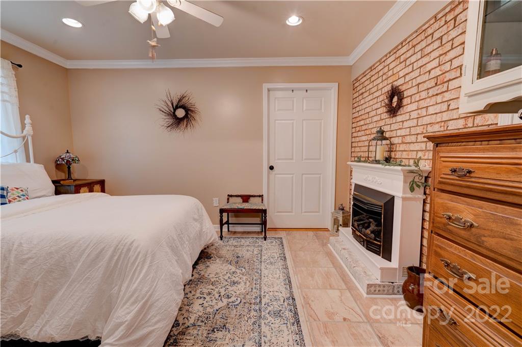 1220 Tot Dellinger Road Cherryville, NC 28021 - Photo 11 of 30 a bedroom with a bed and a fireplace