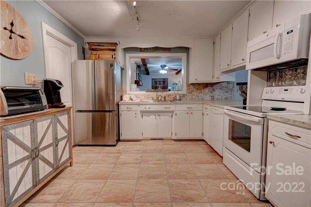 1220 Tot Dellinger Road Cherryville, NC 28021 - Photo 6 of 30 a kitchen with a refrigerator sink and cabinets