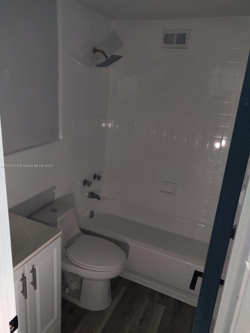 2300 Southwest 3rd Avenue, Unit 9 Miami, FL 33129 - Photo 11 of 13 a white toilet sitting next to a bath tub