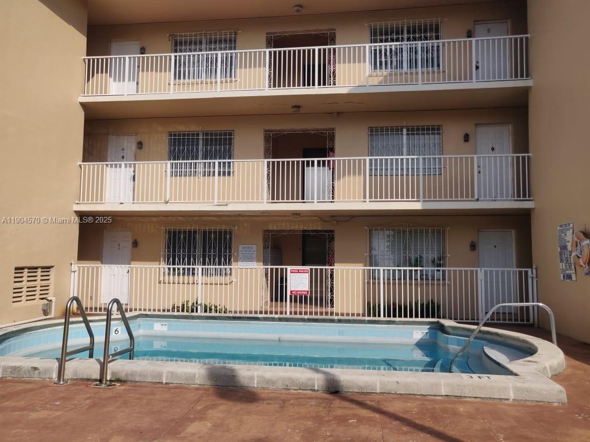 2300 Southwest 3rd Avenue, Unit 9 Miami, FL 33129 - Photo 2 of 13 a front view of a house with a yard