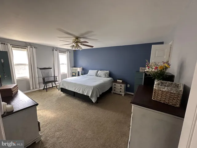 a bedroom with furniture and a window