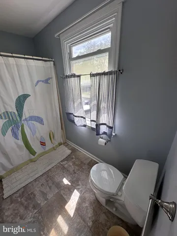 a bathroom with a toilet sink and tub