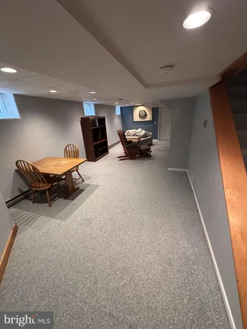 a living room with furniture a window and a flat screen tv