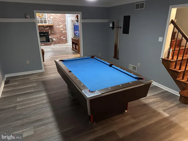 a room with wooden floor and windows