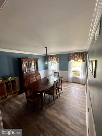 a view of a dining room with furniture and window