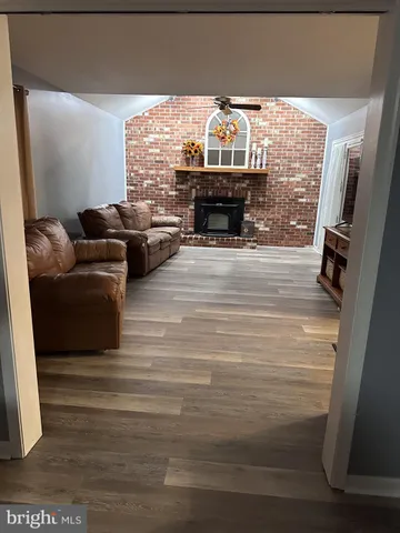 a view of living room with furniture and a fireplace