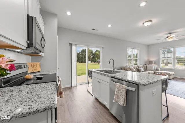 a kitchen with stainless steel appliances granite countertop a stove and a sink