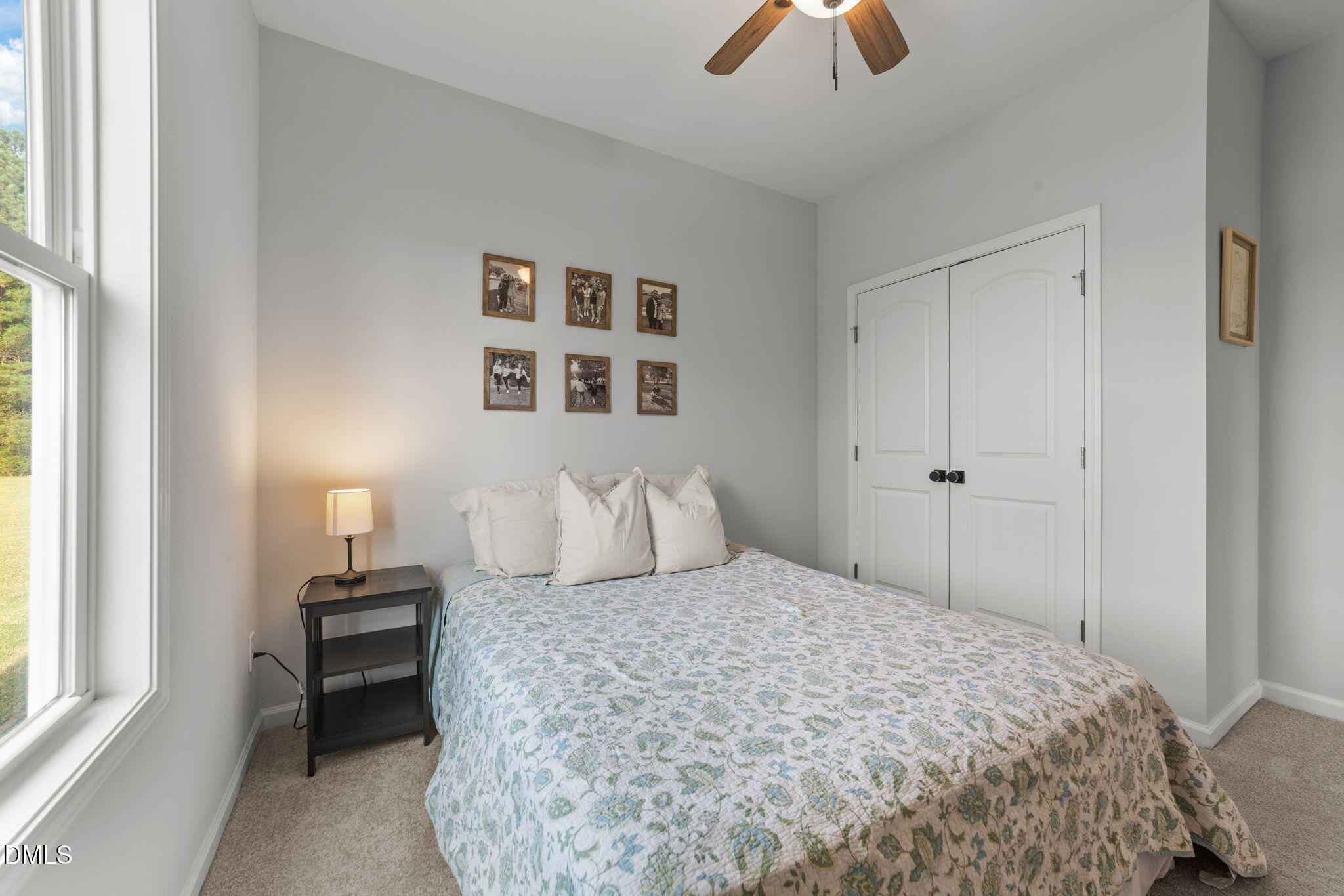 67 Overdrift Court Selma, NC 27576 - Photo 19 of 36 a bedroom with a bed and a chandelier