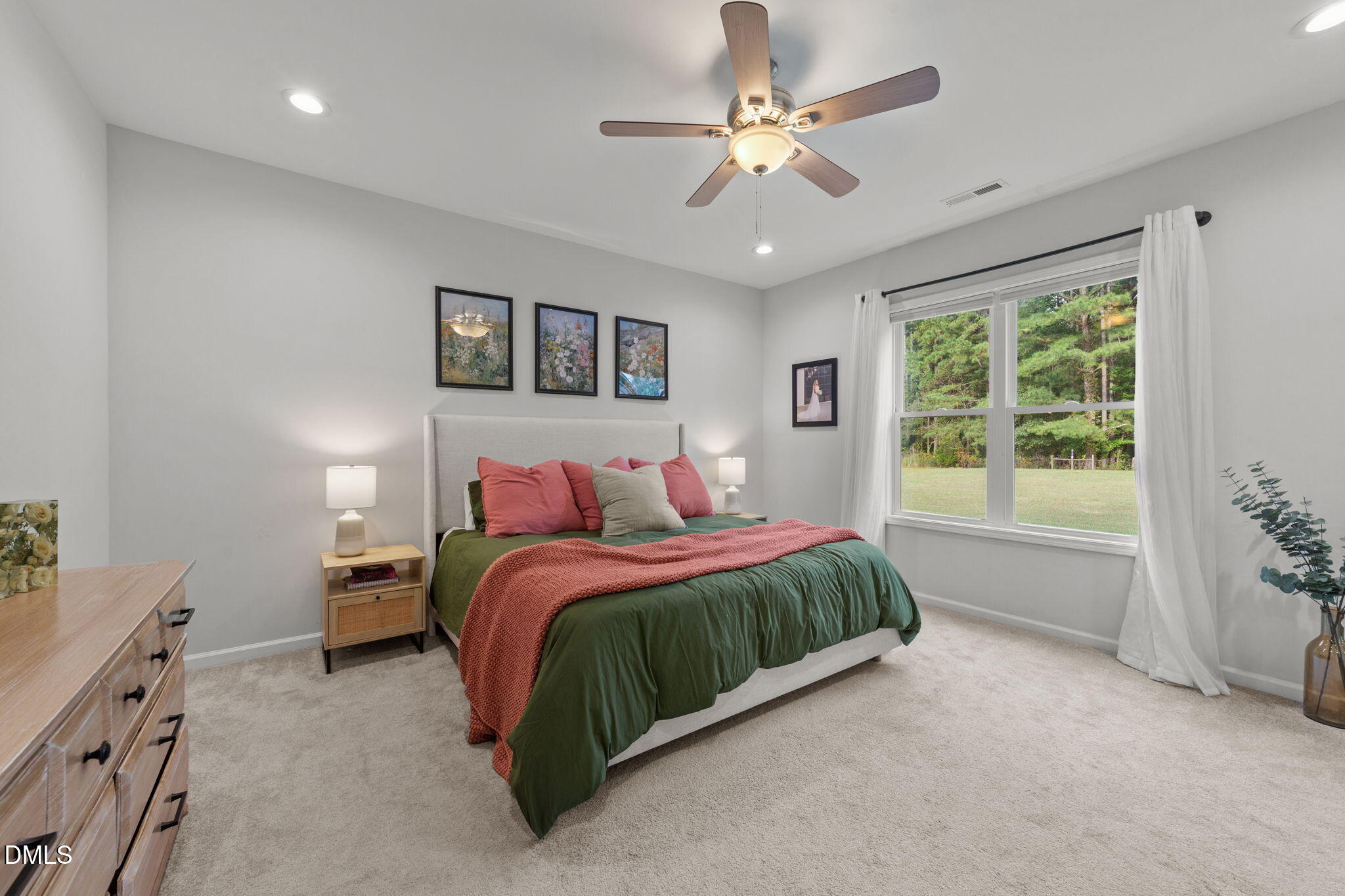 67 Overdrift Court Selma, NC 27576 - Photo 22 of 36 a spacious bedroom with a large bed and a window