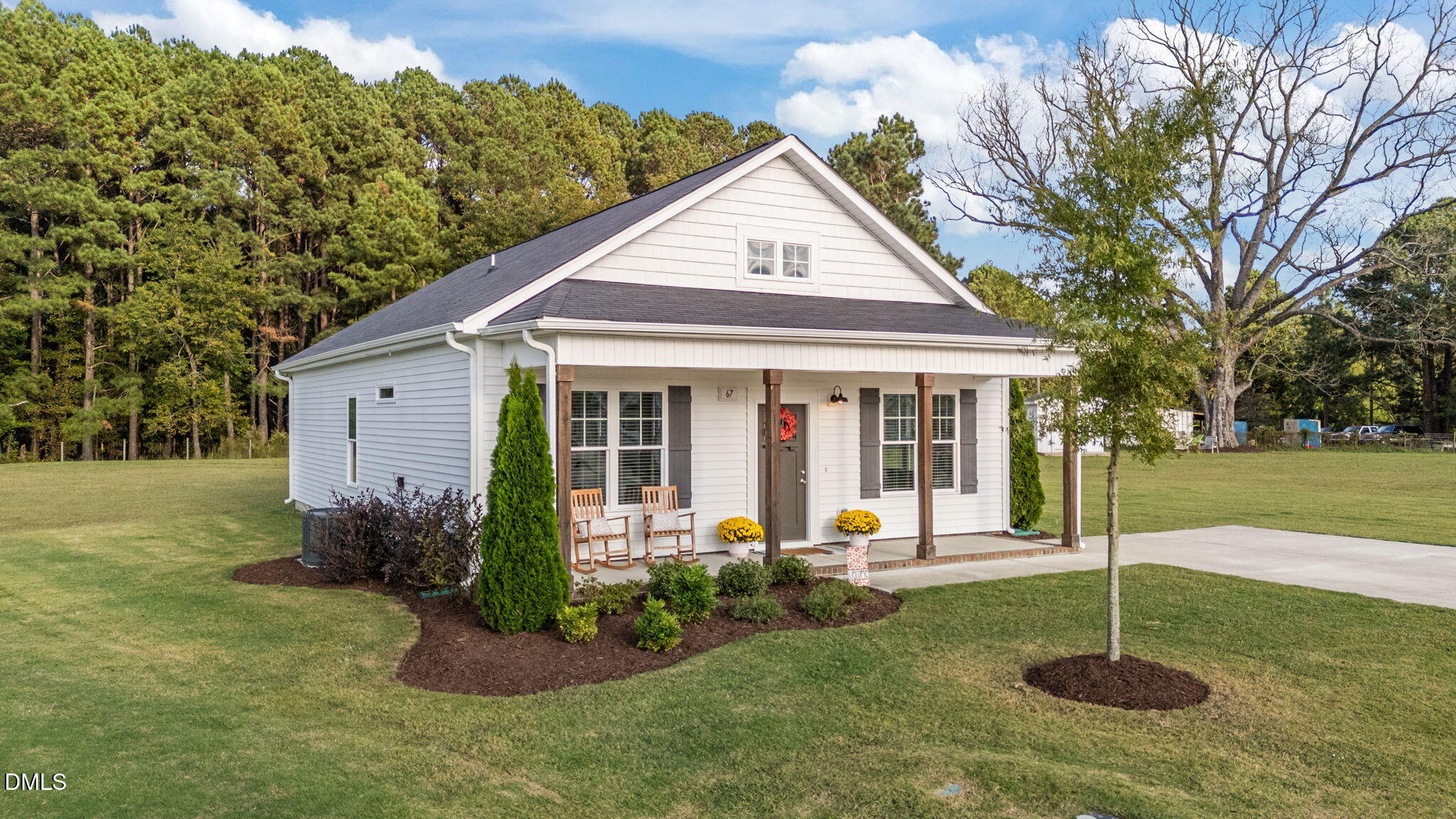 67 Overdrift Court Selma, NC 27576 - Photo 3 of 36 a view of a house with a yard potted plants and a large tree