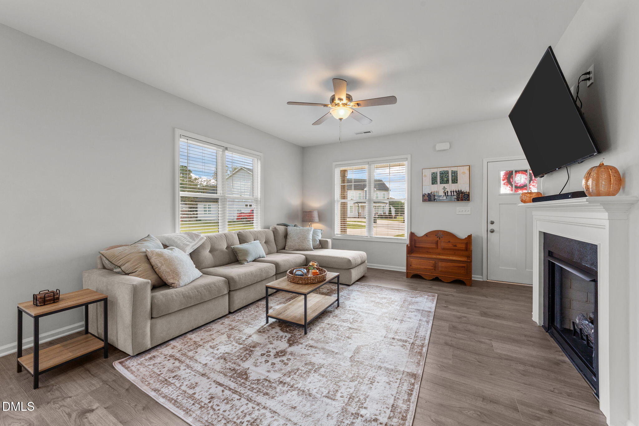 67 Overdrift Court Selma, NC 27576 - Photo 10 of 36 a living room with furniture a fireplace and a flat screen tv