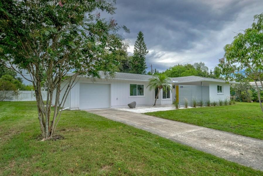 3225 Key Avenue Sarasota, FL 34239 - Photo 1 of 1 a front view of a house with a garden and trees
