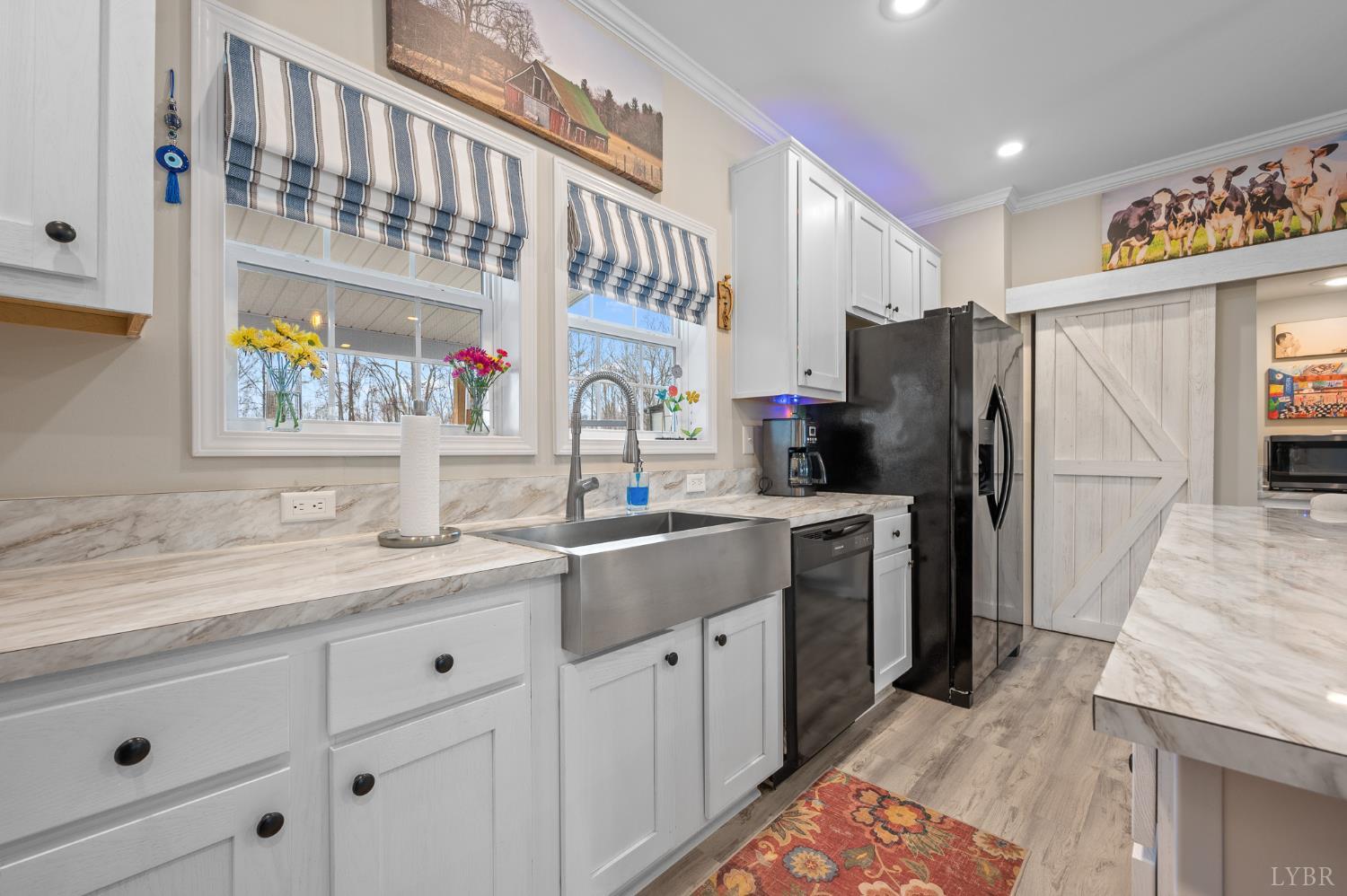 5049 Horseshoe Bend Road Goodview, VA 24095 - Photo 15 of 43 a kitchen with a sink refrigerator and cabinets