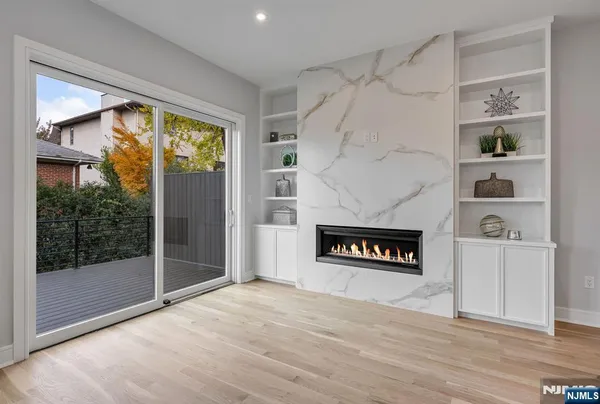 a living room with a fireplace and a floor to ceiling window