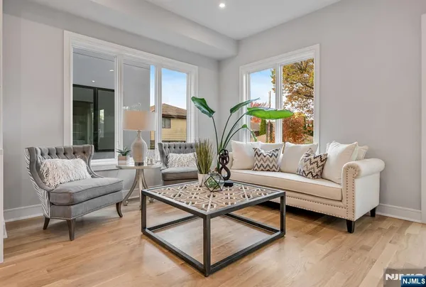 a living room with furniture and a potted plant