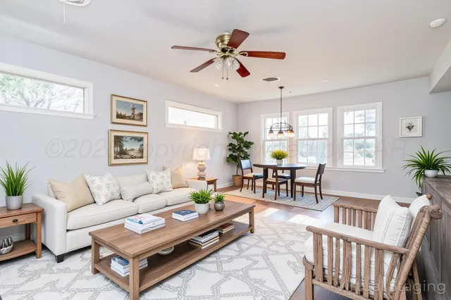 a living room with furniture and wooden floor