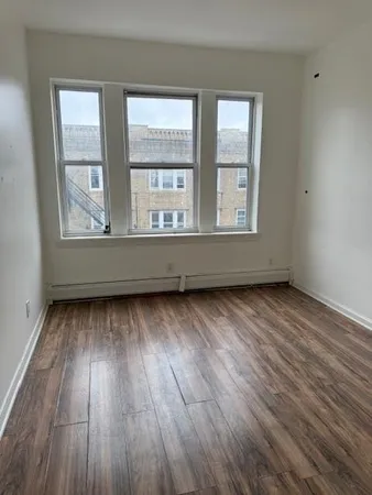 wooden floor and window in an empty room