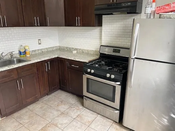 a kitchen with granite countertop cabinets and steel stainless steel appliances