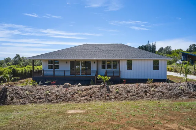 a front view of a house with a garden
