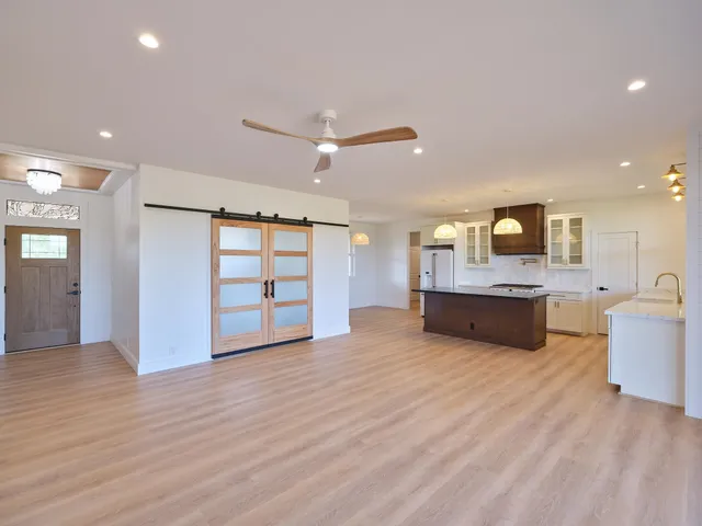 a view of a kitchen with a sink a refrigerator and a window