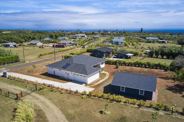 an aerial view of a house with a yard