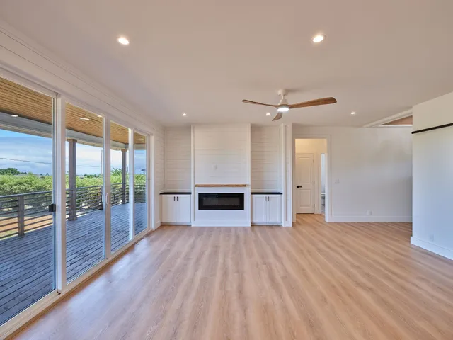 a view of a livingroom with a ceiling fan and window