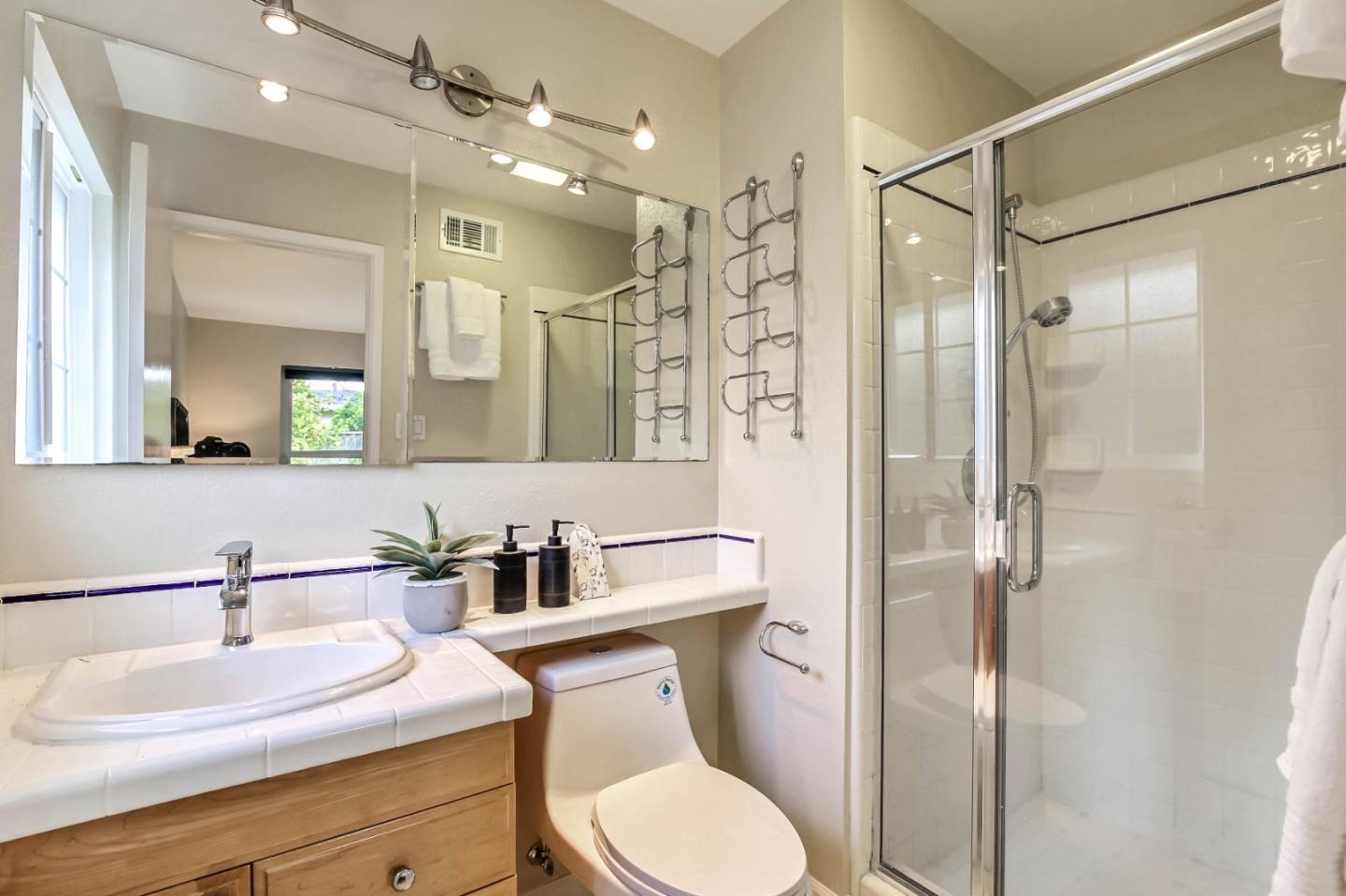744 Cornell Drive Santa Clara, CA 95051 - Photo 13 of 19 a bathroom with a sink toilet a mirror and shower