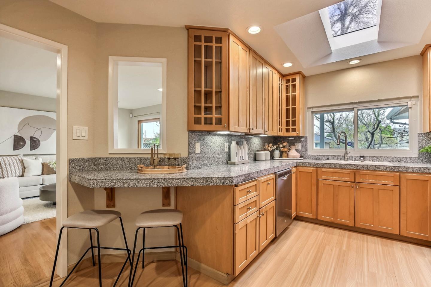 744 Cornell Drive Santa Clara, CA 95051 - Photo 7 of 19 a kitchen with stainless steel appliances granite countertop a stove a sink dishwasher and wooden cabinets with wooden floor