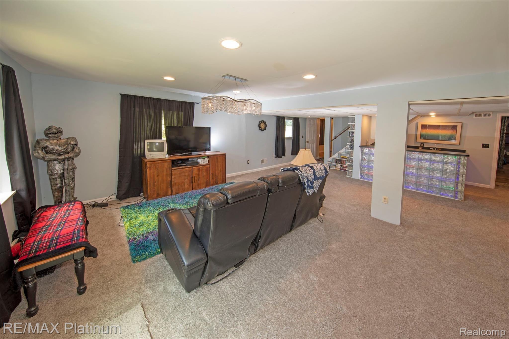542 South Hughes Road Howell, MI 48843 - Photo 15 of 26 Lower Level Family Room with Fun Retro Bar