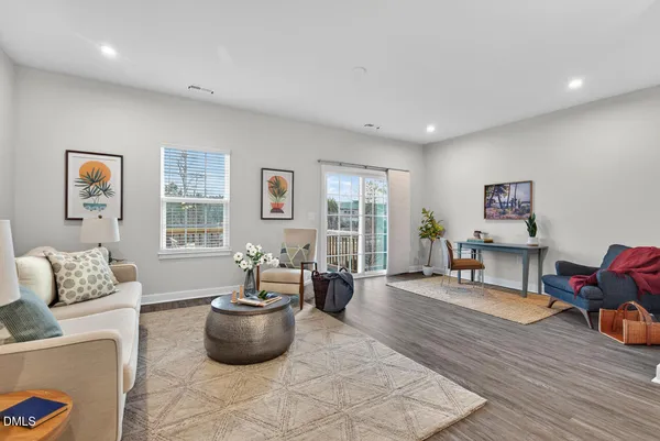 a living room with furniture and wall paintings