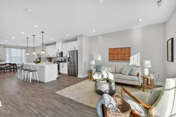 a living room with furniture and kitchen view