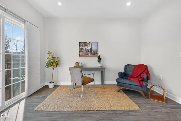 a kitchen with stainless steel appliances a refrigerator a stove a sink dishwasher and a dining table with wooden floor