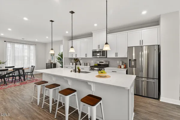 a kitchen with a sink a counter space appliances and cabinets