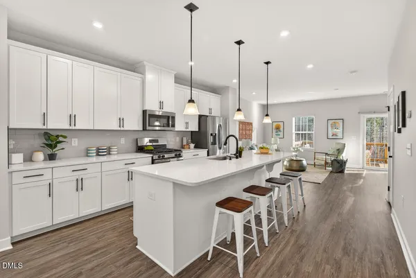 a kitchen with stainless steel appliances white cabinets and a sink